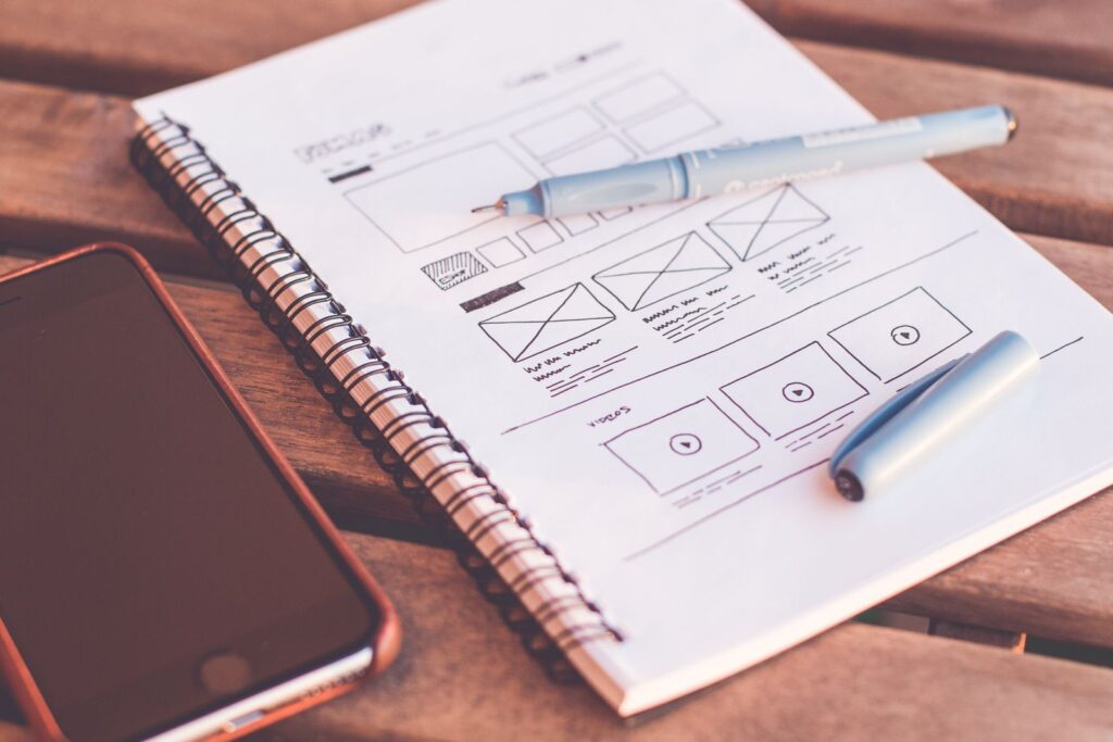 Website wireframe layout sketched in a notebook during the design process